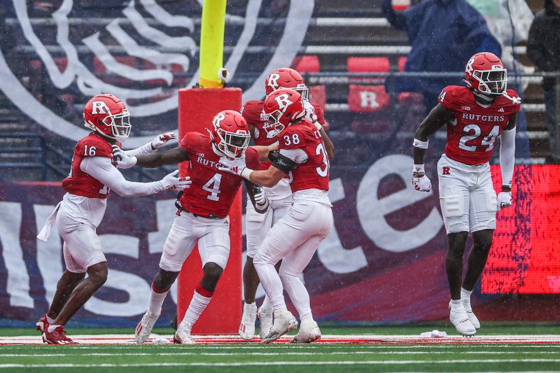 Oct 14, 2023; Piscataway, New Jersey, USA; Rutgers Scarlet Knights running back Aaron Young (4) celebrates with teammates after recovering Michigan State fumble in the end zone for a touchdown during the second half at SHI Stadium. Mandatory Credit: Vincent Carchietta-USA TODAY Sports