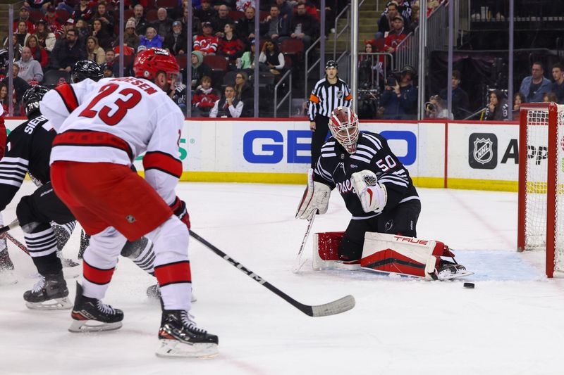 Mar 9, 2024; Newark, New Jersey, USA; New Jersey Devils goaltender Nico Daws (50) makes a save against the Carolina Hurricanes during the first period at Prudential Center. Mandatory Credit: Ed Mulholland-USA TODAY Sports