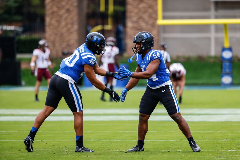 Nov 12, 2022; Durham, North Carolina, USA;  Duke Blue Devils linebacker Jason Hoffman (54) and defensive end Ryan Smith (40) shakes just before the first half against Virginia Tech at Wallace Wade Stadium. Mandatory Credit: Jaylynn Nash-USA TODAY Sports