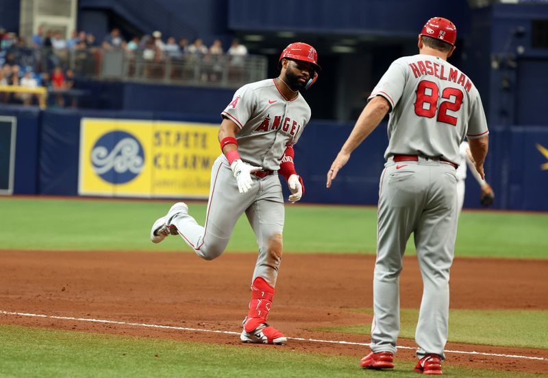 Sep 21, 2023; St. Petersburg, Florida, USA; Los Angeles Angels right fielder Jo Adell (7) is congratulated by third base coach Bill Haselman (82) while rounding the bases after hitting a two-run home run against the Tampa Bay Rays during the sixth inning at Tropicana Field. Mandatory Credit: Kim Klement Neitzel-USA TODAY Sports