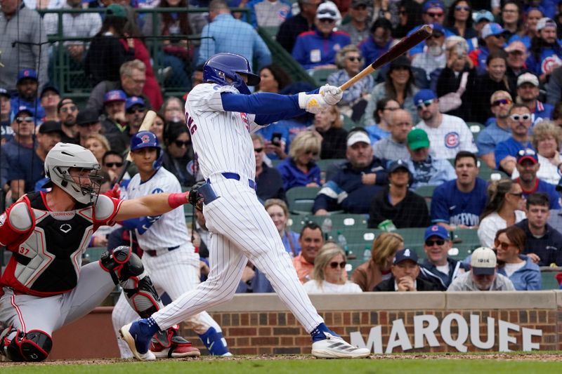 Sep 27, 2024; Chicago, Illinois, USA; Chicago Cubs outfielder Pete Crow-Armstrong (52) hits a single against the Cincinnati Reds during the eighth inning at Wrigley Field. Mandatory Credit: David Banks-Imagn Images