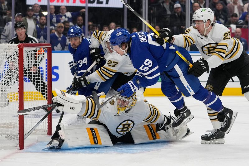 Apr 24, 2024; Toronto, Ontario, CAN; Boston Bruins goaltender Jeremy Swayman (1) makes a save on Toronto Maple Leafs forward Tyler Bertuzzi (59) as Boston Bruins defenseman Brandon Carlo (25) helps defend during the third period of game three of the first round of the 2024 Stanley Cup Playoffs at Scotiabank Arena. Mandatory Credit: John E. Sokolowski-USA TODAY Sports