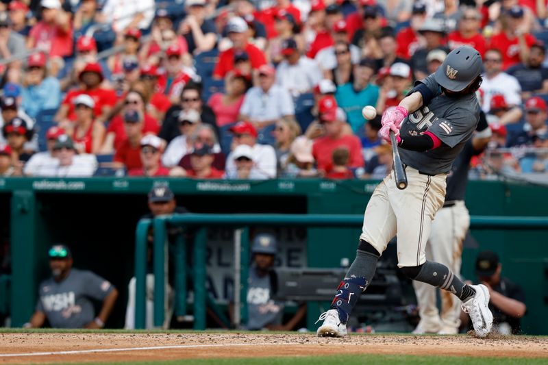May 25, 2024; Washington, District of Columbia, USA; Washington Nationals outfielder Jesse Winker (6) singles against the Seattle Mariners during the seventh inning at Nationals Park. Mandatory Credit: Geoff Burke-USA TODAY Sports