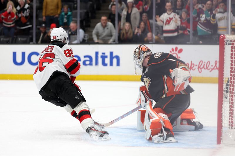 Mar 1, 2024; Anaheim, California, USA; Anaheim Ducks goaltender Lukas Dostal (1) stops the penalty shot by New Jersey Devils center Jack Hughes (86) during the third period at Honda Center. Mandatory Credit: Kiyoshi Mio-USA TODAY Sports