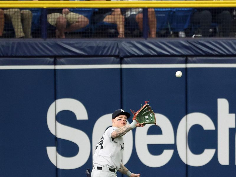 May 10, 2024; St. Petersburg, Florida, USA;  New York Yankees outfielder Alex Verdugo (24) catches a fly ball against the Tampa Bay Rays during the seventh inning cat Tropicana Field. Mandatory Credit: Kim Klement Neitzel-USA TODAY Sports