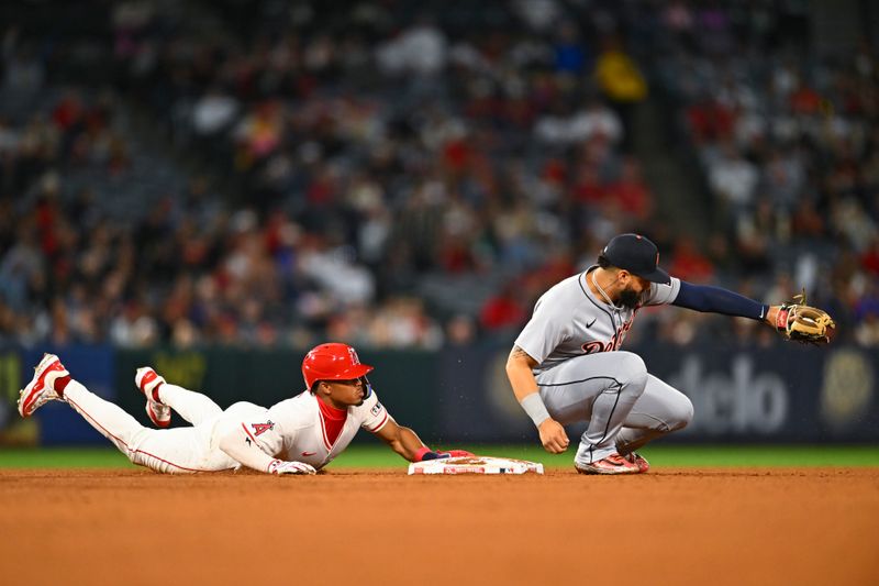 May 3, 2025; Anaheim, California, USA; Los Angeles Angels outfielder Kyren Paris (19) slides into second base against Detroit Tigers second baseman Gleyber Torres (25) during the sixth inning at Angel Stadium. Mandatory Credit: Jonathan Hui-Imagn Images