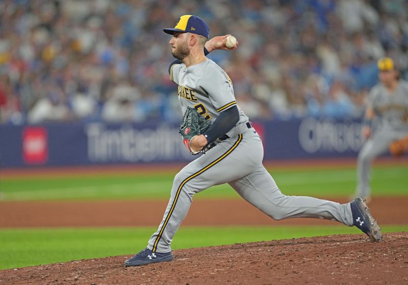 May 31, 2023; Toronto, Ontario, CAN; Milwaukee Brewers relief pitcher Peter Strzelecki (32) throws a pitch against the Toronto Blue Jays during the eighth inning at Rogers Centre. Mandatory Credit: Nick Turchiaro-USA TODAY Sports