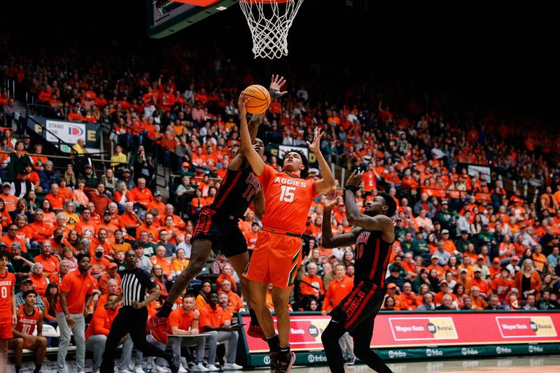 Jan 19, 2024; Fort Collins, Colorado, USA; Colorado State Rams guard Jalen Lake (15) drives to the net against UNLV Rebels guard Luis Rodriguez (15) and forward Kalib Boone (10) in the second half at Moby Arena. Mandatory Credit: Isaiah J. Downing-USA TODAY Sports