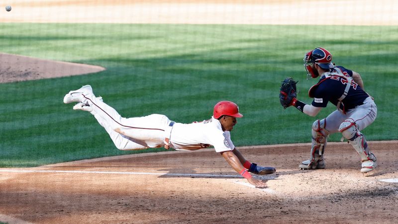 Aug 17, 2023; Washington, District of Columbia, USA; Washington Nationals second baseman Jeter Downs (3) scores a run ahead of a tag by Boston Red Sox catcher Connor Wong (12) on a two run double by Nationals designated hitter Joey Meneses (not pictured) during the fifth inning at Nationals Park. Mandatory Credit: Geoff Burke-USA TODAY Sports