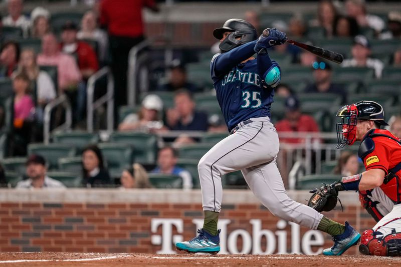 May 19, 2023; Cumberland, Georgia, USA; Seattle Mariners right fielder Teoscar Hernandez (35) singles to drive in a run against the Atlanta Braves during the seventh inning at Truist Park. Mandatory Credit: Dale Zanine-USA TODAY Sports