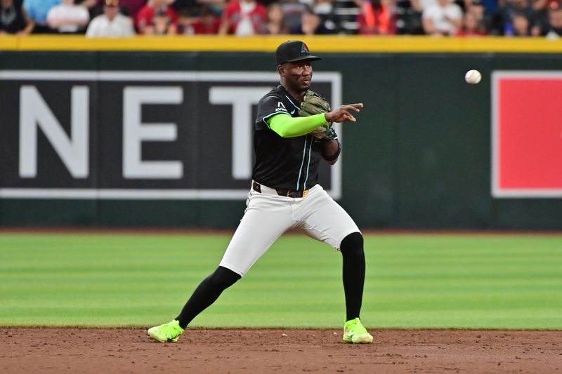 Jul 29, 2024; Phoenix, Arizona, USA;  Arizona Diamondbacks shortstop Geraldo Perdomo (2) throws to first base in the third inning against the Washington Nationals at Chase Field. Mandatory Credit: Matt Kartozian-USA TODAY Sports