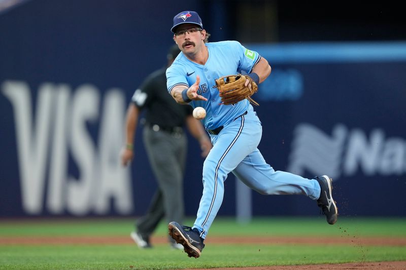 May 22, 2024; Toronto, Ontario, CAN; Toronto Blue Jays second baseman Davis Schneider (36) throws to first bae to get out Chicago White Sox left fielder Andrew Benintendi (not pictured) during the third inning at Rogers Centre. Mandatory Credit: John E. Sokolowski-USA TODAY Sports