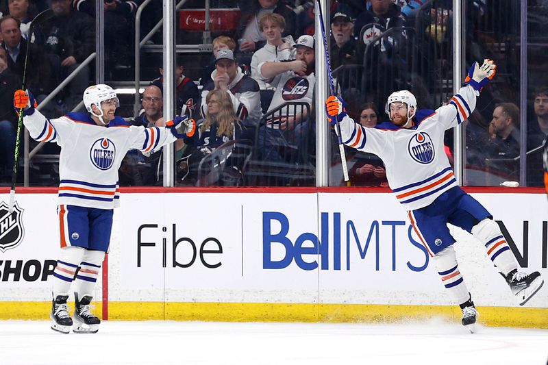 Mar 26, 2024; Winnipeg, Manitoba, CAN; Edmonton Oilers center Derek Ryan (10) celebrates the second period goal by Edmonton Oilers right wing Connor Brown (28) against the Winnipeg Jets at Canada Life Centre. Mandatory Credit: James Carey Lauder-USA TODAY Sports