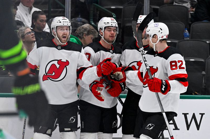 Mar 14, 2024; Dallas, Texas, USA; New Jersey Devils center Chris Tierney (11) and right wing Alexander Holtz (10) and defenseman Brendan Smith (2) and defenseman Santeri Hatakka (82) celebrates a goal scored by Holtz against the Dallas Stars during the third period at the American Airlines Center. Mandatory Credit: Jerome Miron-USA TODAY Sports