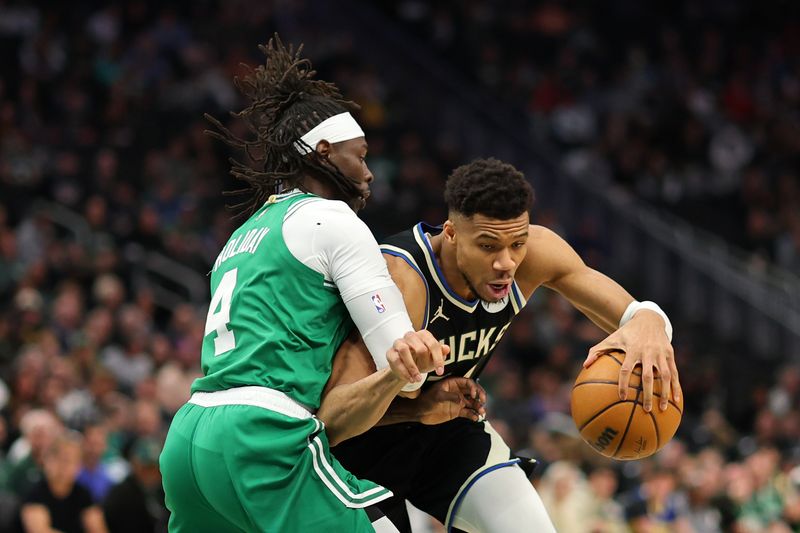 MILWAUKEE, WISCONSIN - APRIL 09: Giannis Antetokounmpo #34 of the Milwaukee Bucks drives around Jrue Holiday #4 of the Boston Celtics during the first half of a game at Fiserv Forum on April 09, 2024 in Milwaukee, Wisconsin. NOTE TO USER: User expressly acknowledges and agrees that, by downloading and or using this photograph, User is consenting to the terms and conditions of the Getty Images License Agreement. (Photo by Stacy Revere/Getty Images)