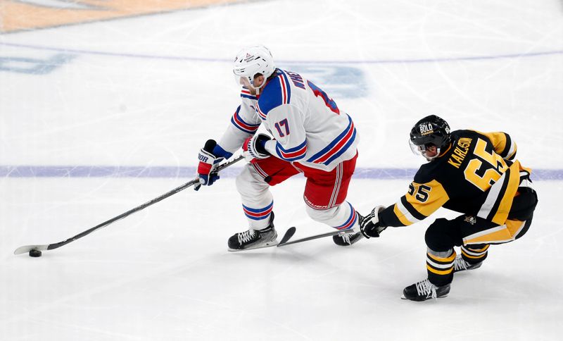 Nov 22, 2023; Pittsburgh, Pennsylvania, USA; New York Rangers right wing Blake Wheeler (17) moves the puck against Pittsburgh Penguins defenseman Erik Karlsson (65) during the third period at PPG Paints Arena. The Rangers won 1-0. Mandatory Credit: Charles LeClaire-USA TODAY Sports