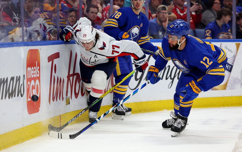 Apr 11, 2024; Buffalo, New York, USA;  Washington Capitals right wing T.J. Oshie (77) and Buffalo Sabres left wing Jordan Greenway (12) go after a loose puck during the first period at KeyBank Center. Mandatory Credit: Timothy T. Ludwig-USA TODAY Sports