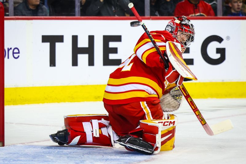 Nov 11, 2024; Calgary, Alberta, CAN; Calgary Flames goaltender Dustin Wolf (32) makes a save against the Los Angeles Kings during the first period at Scotiabank Saddledome. Mandatory Credit: Sergei Belski-Imagn Images