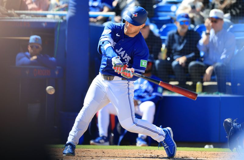 Feb 24, 2026; Dunedin, Florida, USA;  Toronto Blue Jays designated hitter Daulton Varsho (5) triples during the first inning against the New York Yankees at TD Ballpark. Mandatory Credit: Kim Klement Neitzel-Imagn Images