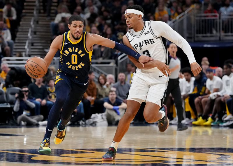 INDIANAPOLIS, INDIANA - NOVEMBER 06: Tyrese Haliburton #0 of the Indiana Pacers dribbles the ball while being guarded by Keldon Johnson #3 of the San Antonio Spurs in the third quarter at Gainbridge Fieldhouse on November 06, 2023 in Indianapolis, Indiana. NOTE TO USER: User expressly acknowledges and agrees that, by downloading and or using this photograph, User is consenting to the terms and conditions of the Getty Images License Agreement. (Photo by Dylan Buell/Getty Images)