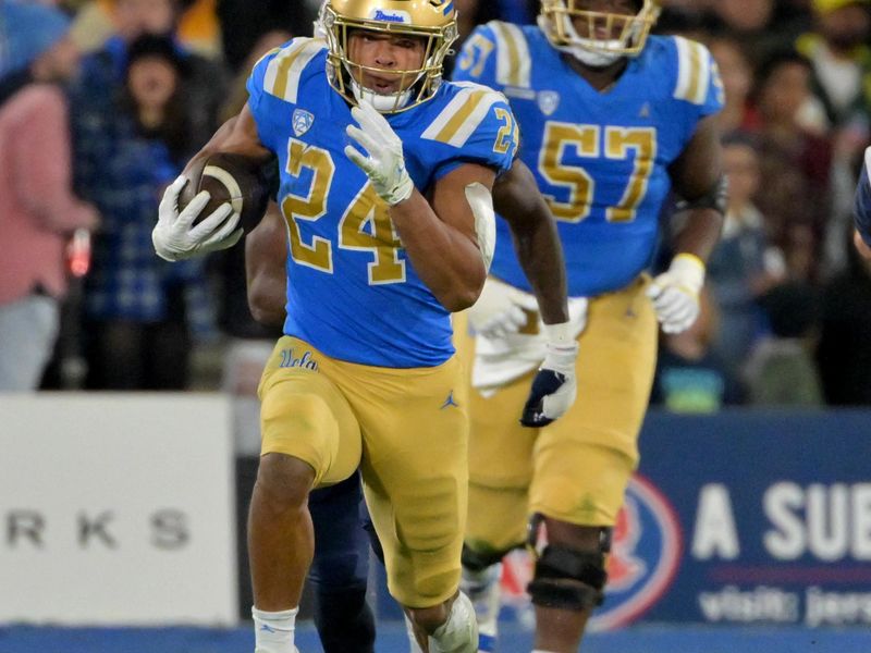 Nov 12, 2022; Pasadena, California, USA;   UCLA Bruins running back Zach Charbonnet (24) carries for 37 yards before he is forced out of bounds by Arizona Wildcats safety Christian Young (5) in the first half at the Rose Bowl. Mandatory Credit: Jayne Kamin-Oncea-USA TODAY Sports