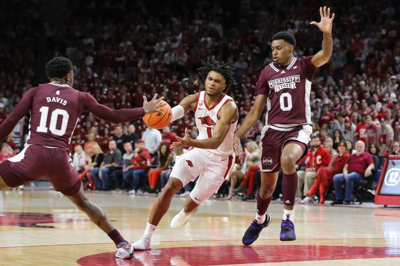 Feb 11, 2023; Fayetteville, Arkansas, USA; Arkansas Razorbacks guard Ricky Council Jr (1) dribbles between Mississippi State Bulldogs guard Dashawn Davis (10) and forward D.J. Jeffries (0) during the first half at Bud Walton Arena. Mandatory Credit: Nelson Chenault-USA TODAY Sports