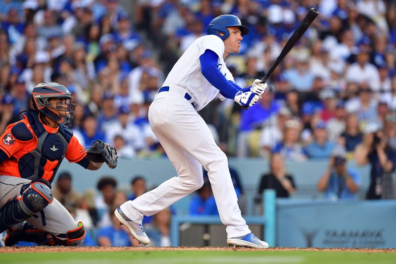 Jun 25, 2023; Los Angeles, California, USA; Los Angeles Dodgers first baseman Freddie Freeman (5) hits an RBI double against the Houston Astros during the eighth inning at Dodger Stadium. Mandatory Credit: Gary A. Vasquez-USA TODAY Sports