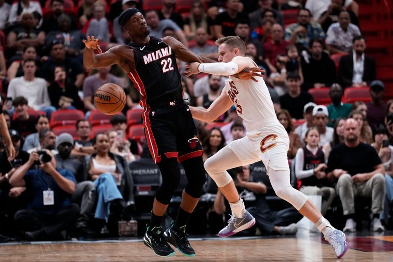 MIAMI, FLORIDA - MARCH 24: Jimmy Butler #22 of the Miami Heat dribbles the ball against Sam Merrill #5 of the Cleveland Cavaliers during the first quarter at Kaseya Center on March 24, 2024 in Miami, Florida. NOTE TO USER: User expressly acknowledges and agrees that, by downloading and or using this photograph, User is consenting to the terms and conditions of the Getty Images License Agreement. (Photo by Rich Storry/Getty Images)