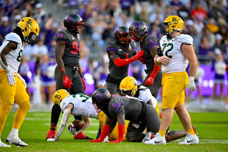 Nov 18, 2023; Fort Worth, Texas, USA; TCU Horned Frogs defensive lineman Micheal Ibukun-Okeyode (94) and safety Abe Camara (1) and linebacker Namdi Obiazor (4) celebrate after making a defensive stop against the Baylor Bears during the second half at Amon G. Carter Stadium. Mandatory Credit: Jerome Miron-USA TODAY Sports