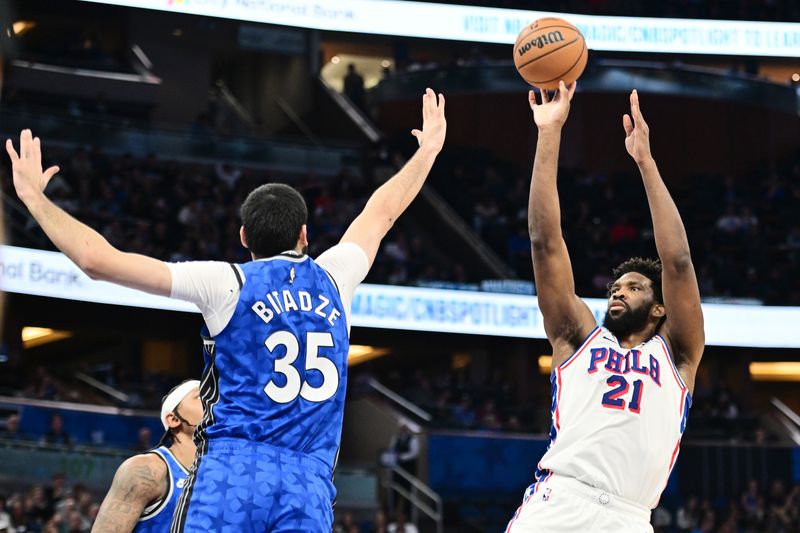 ORLANDO, FLORIDA - JANUARY 19: Joel Embiid #21 of the Philadelphia 76ers shoots the ball against Goga Bitadze #35 of the Orlando Magic in the first half of a game at Kia Center on January 19, 2024 in Orlando, Florida. NOTE TO USER: User expressly acknowledges and agrees that, by downloading and or using this photograph, User is consenting to the terms and conditions of the Getty Images License Agreement. (Photo by Julio Aguilar/Getty Images)