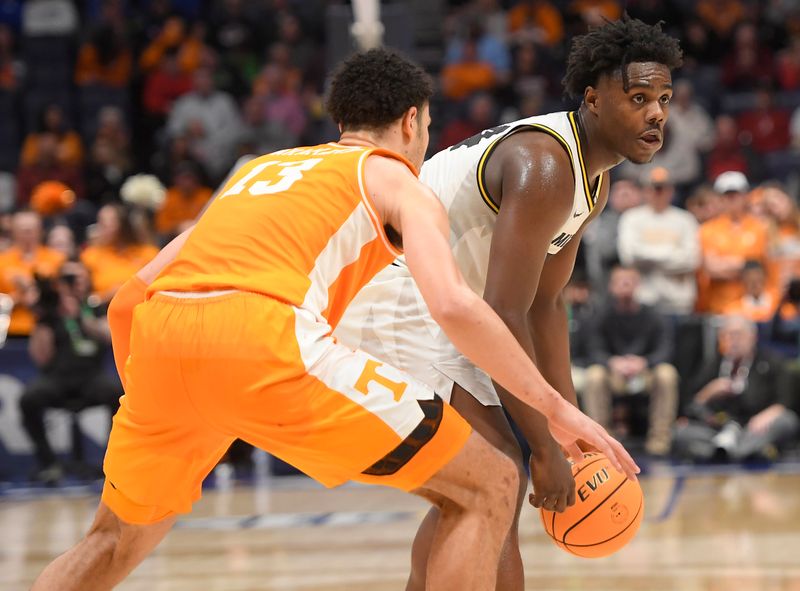 Mar 10, 2023; Nashville, TN, USA;  Missouri Tigers guard Kobe Brown (24) watches as Tennessee Volunteers forward Olivier Nkamhoua (13) guards during the second half at Bridgestone Arena. Mandatory Credit: Steve Roberts-USA TODAY Sports