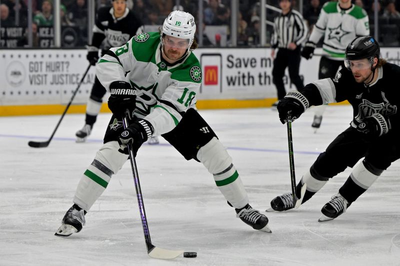 Jan 12, 2026; Los Angeles, California, USA; Dallas Stars center Sam Steel (18) is defended by Los Angeles Kings right wing Adrian Kempe (9) as he handles the puck in the third period at Crypto.com Arena. Mandatory Credit: Jayne Kamin-Oncea-Imagn Images