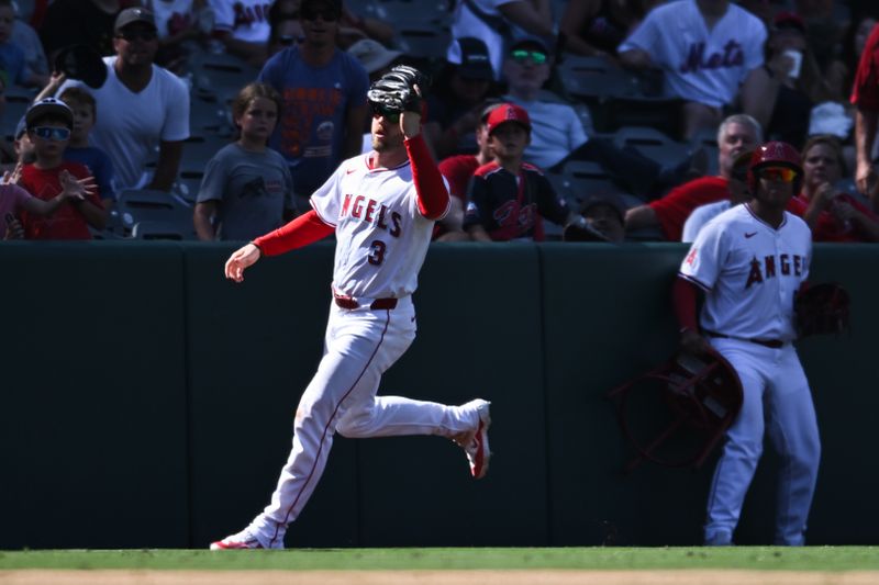 Aug 4, 2024; Anaheim, California, USA; Los Angeles Angels outfielder Taylor Ward (3) makes a catch against the New York Mets during the ninth inning at Angel Stadium. Mandatory Credit: Jonathan Hui-USA TODAY Sports
