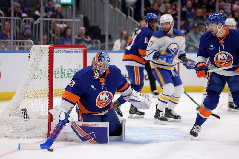 Jan 24, 2026; Elmont, New York, USA; New York Islanders goaltender David Rittich (33) plays the puck against the Buffalo Sabres during the first period at UBS Arena. Mandatory Credit: Brad Penner-Imagn Images