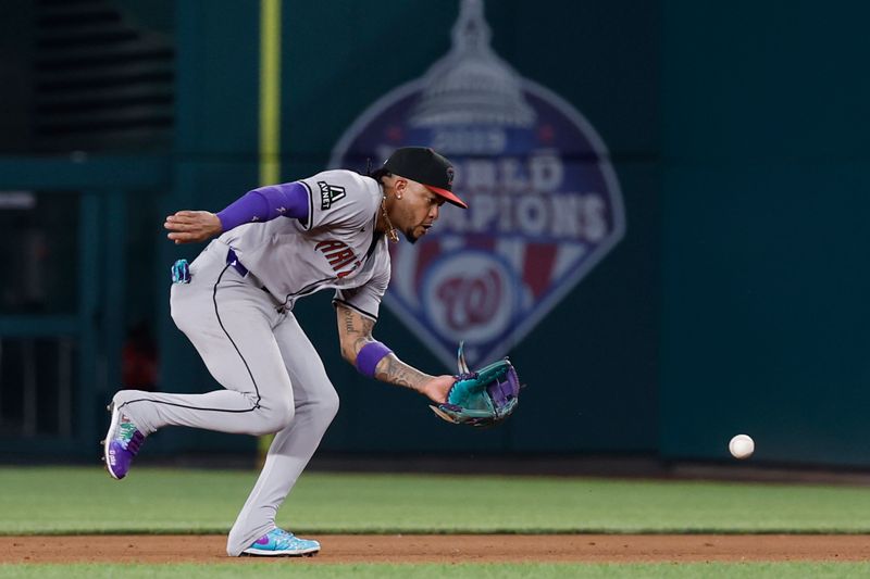 Jun 18, 2024; Washington, District of Columbia, USA; Arizona Diamondbacks second base Ketel Marte (4) fields a ground ball by Washington Nationals third base Nick Senzel (not pictured) during the eighth inning at Nationals Park. Mandatory Credit: Geoff Burke-USA TODAY Sports