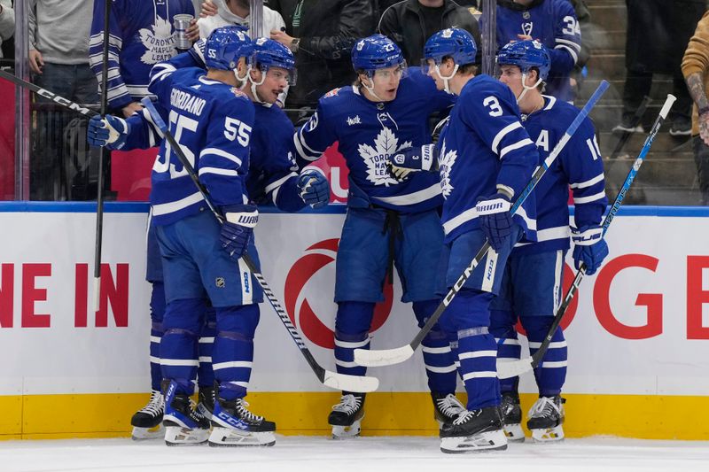 Nov 6, 2023; Toronto, Ontario, CAN; Toronto Maple Leafs forward Matthew Knies (23) celebrates his goal against the Tampa Bay Lightning with Toronto Maple Leafs forward Auston Matthews (34), defenseman Mark Giordano (55), defenseman John Klingberg (3), and forward Mitchell Marner (16) during the first period at Scotiabank Arena. Mandatory Credit: John E. Sokolowski-USA TODAY Sports