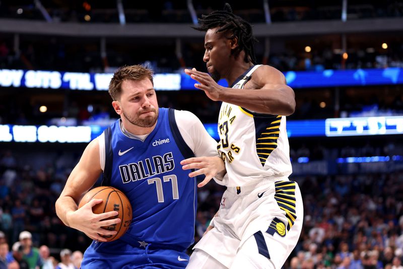 DALLAS, TEXAS - MARCH 05: Luka Doncic #77 of the Dallas Mavericks drives to the basket against Aaron Nesmith #23 of the Indiana Pacers in the first half at American Airlines Center on March 05, 2024 in Dallas, Texas. NOTE TO USER: User expressly acknowledges and agrees that, by downloading and or using this photograph, User is consenting to the terms and conditions of the Getty Images License Agreement. (Photo by Tim Heitman/Getty Images)