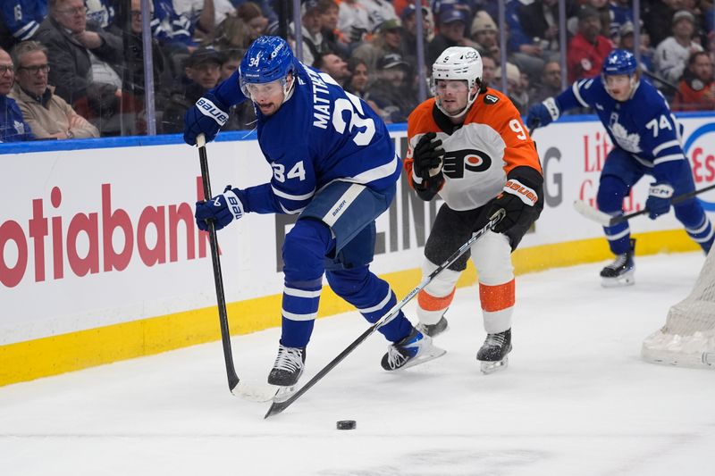 Mar 2, 2026; Toronto, Ontario, CAN; Toronto Maple Leafs forward Auston Matthews (34) passes the puck as Philadelphia Flyers defenseman Jamie Drysdale (9) defends during the first period at Scotiabank Arena. Mandatory Credit: John E. Sokolowski-Imagn Images