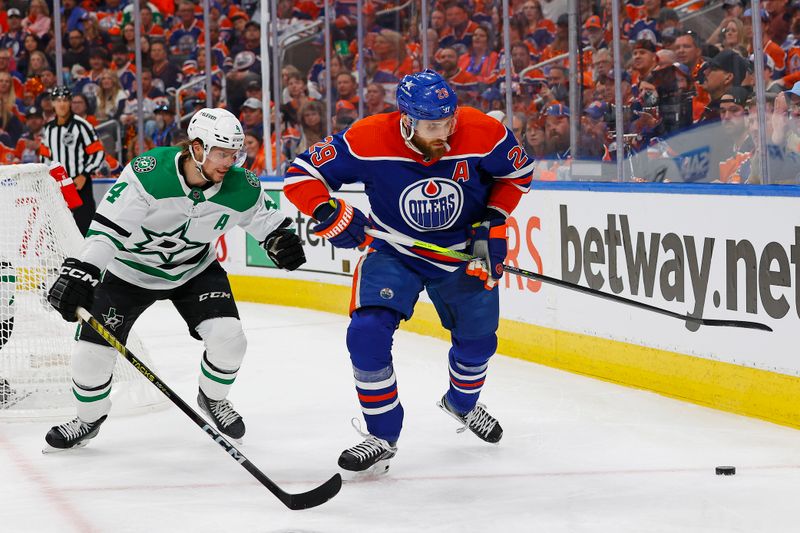 Jun 2, 2024; Edmonton, Alberta, CAN; Edmonton Oilers forward Leon Draisaitl (29) protects the puck from Dallas Stars defensemen Miro Heiskanen (4) during the first period in game six of the Western Conference Final of the 2024 Stanley Cup Playoffs at Rogers Place. Mandatory Credit: Perry Nelson-USA TODAY Sports