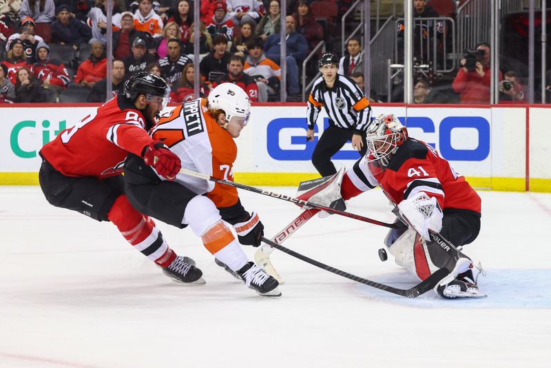 Dec 19, 2023; Newark, New Jersey, USA; New Jersey Devils goaltender Vitek Vanecek (41) makes a save on Philadelphia Flyers right wing Owen Tippett (74) during the third period at Prudential Center. Mandatory Credit: Ed Mulholland-USA TODAY Sports