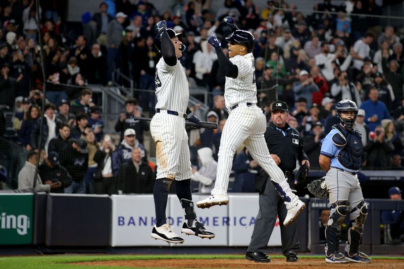 Apr 19, 2024; Bronx, New York, USA; New York Yankees right fielder Juan Soto (22) celebrates with center fielder Aaron Judge (99) after hitting a three run home run against the Tampa Bay Rays during the seventh inning at Yankee Stadium. Mandatory Credit: Brad Penner-USA TODAY Sports