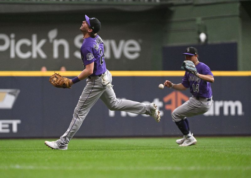 Aug 7, 2023; Milwaukee, Wisconsin, USA; Colorado Rockies third baseman Ryan McMahon (24) looses sight of the ball and it drops in the outfield against the Colorado Rockies in the fourth inning at American Family Field. Mandatory Credit: Michael McLoone-USA TODAY Sports