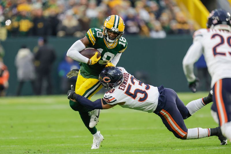 Green Bay Packers wide receiver Malik Heath (18) is hit after making a catch by Chicago Bears linebacker T.J. Edwards (53) during an NFL football game between the Green Bay Packers and Chicago Bears Sunday, Jan. 7, 2024, in Green Bay, Wis. (AP Photo/Matt Ludtke)