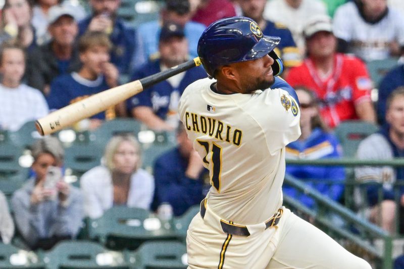 Jun 10, 2025; Milwaukee, Wisconsin, USA; Milwaukee Brewers center fielder Jackson Chourio (11) hits a two run home run in the third inning against the Atlanta Braves at American Family Field. Mandatory Credit: Benny Sieu-Imagn Images
