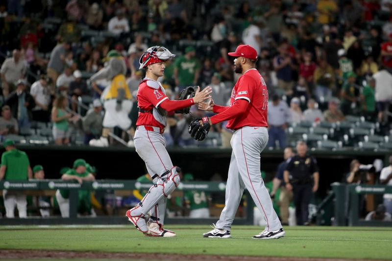 May 19, 2025; West Sacramento, California, USA; Los Angeles Angels pitcher Kenley Jansen (74) and catcher Logan O'Hoppe (14) shake hands after defeating the Athletics 4-3 at Sutter Health Park. Mandatory Credit: Dennis Lee-Imagn Images