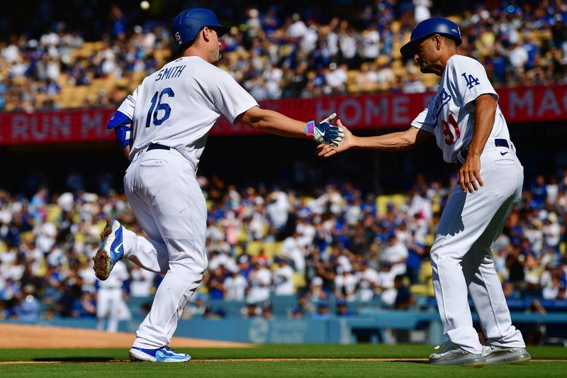 Jun 24, 2023; Los Angeles, California, USA; Los Angeles Dodgers catcher Will Smith (16) is greeted by third base coach Dino Ebel (91) after hitting a solo home run against the Houston Astros during the first inning at Dodger Stadium. Mandatory Credit: Gary A. Vasquez-USA TODAY Sports