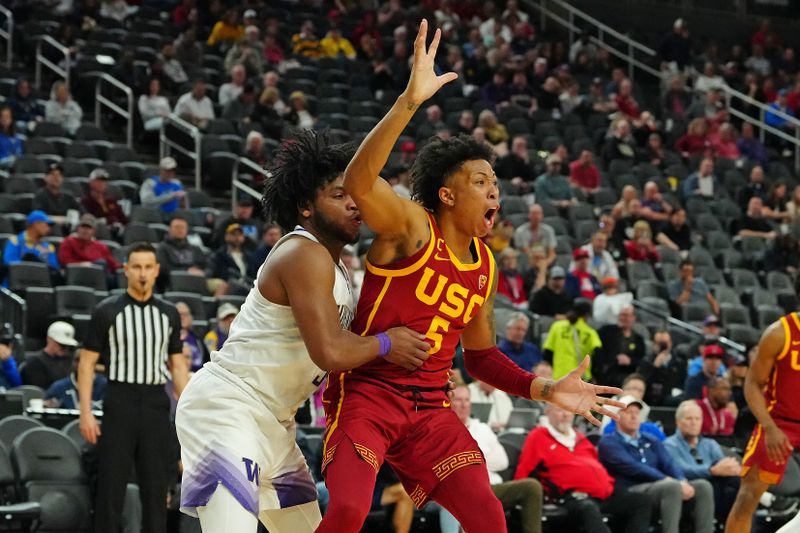 Mar 13, 2024; Las Vegas, NV, USA; USC Trojans guard Boogie Ellis (5) calls for a pass as Washington Huskies guard Sahvir Wheeler (5) defends during the second half at T-Mobile Arena. Mandatory Credit: Stephen R. Sylvanie-USA TODAY Sports