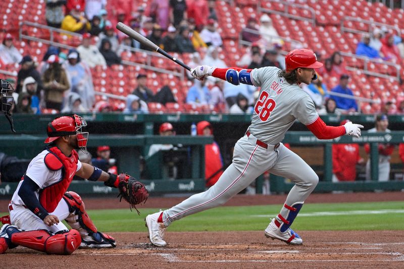 Apr 10, 2024; St. Louis, Missouri, USA;  Philadelphia Phillies third baseman Alec Bohm (28) hits a one run single against the St. Louis Cardinals during the first inning at Busch Stadium. Mandatory Credit: Jeff Curry-USA TODAY Sports