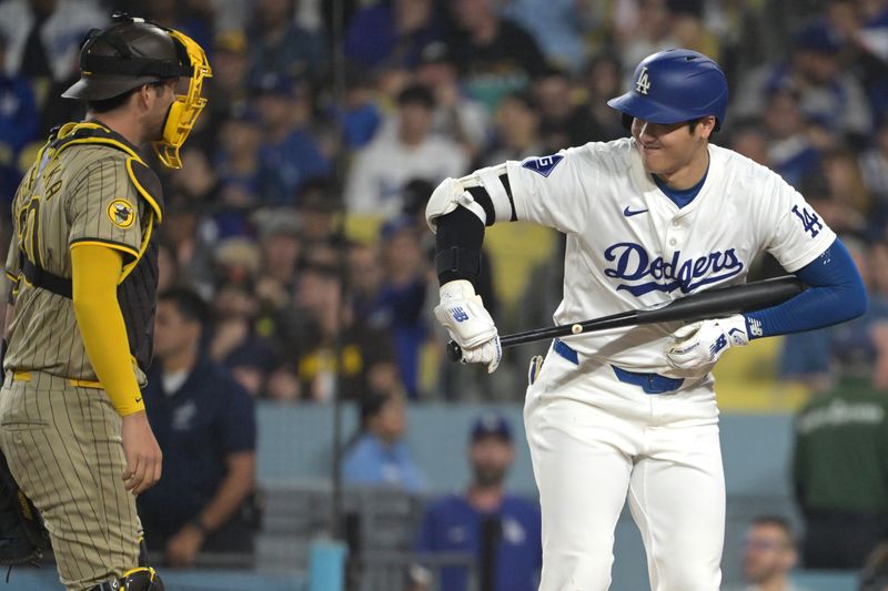 Sep 26, 2024; Los Angeles, California, USA;  Los Angeles Dodgers designated hitter Shohei Ohtani (17) acknowledges San Diego Padres catcher Kyle Higashioka (20) during his first at bat in the first inning at Dodger Stadium. Mandatory Credit: Jayne Kamin-Oncea-Imagn Images