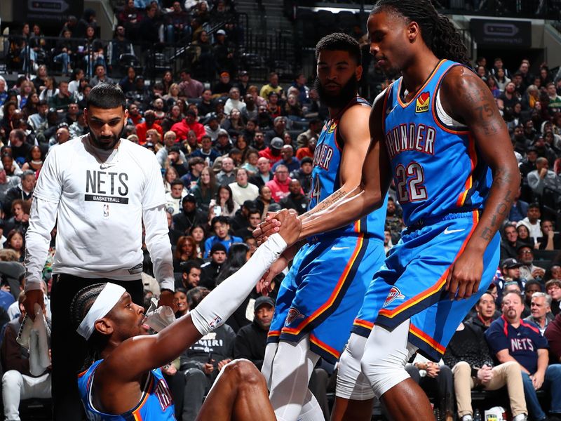 BROOKLYN, NY - JANUARY 5: Cason Wallace #22 of the Oklahoma City Thunder  & Kenrich Williams #34 of the Oklahoma City Thunder help teammate Shai Gilgeous-Alexander #2 of the Oklahoma City Thunder up during the game on January 5, 2024 at Barclays Center in Brooklyn, New York. NOTE TO USER: User expressly acknowledges and agrees that, by downloading and or using this Photograph, user is consenting to the terms and conditions of the Getty Images License Agreement. Mandatory Copyright Notice: Copyright 2024 NBAE (Photo by David L. Nemec/NBAE via Getty Images)